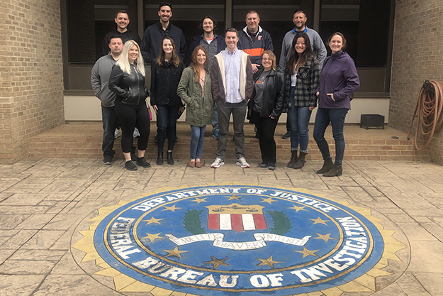The group poses for a photo on their tour of the FBI Academy.